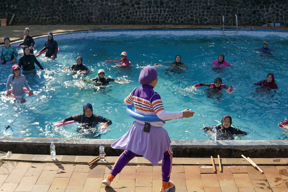 Women participating in a water aerobics class under the sun in West Java, Indonesia.
